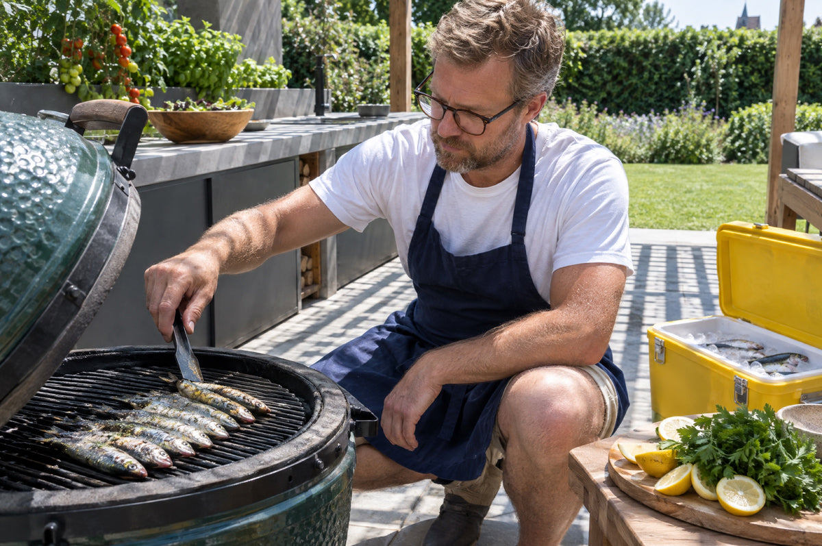 A man lays fresh sardines on a garden grill under a pergola with a yellow cool box beside him.